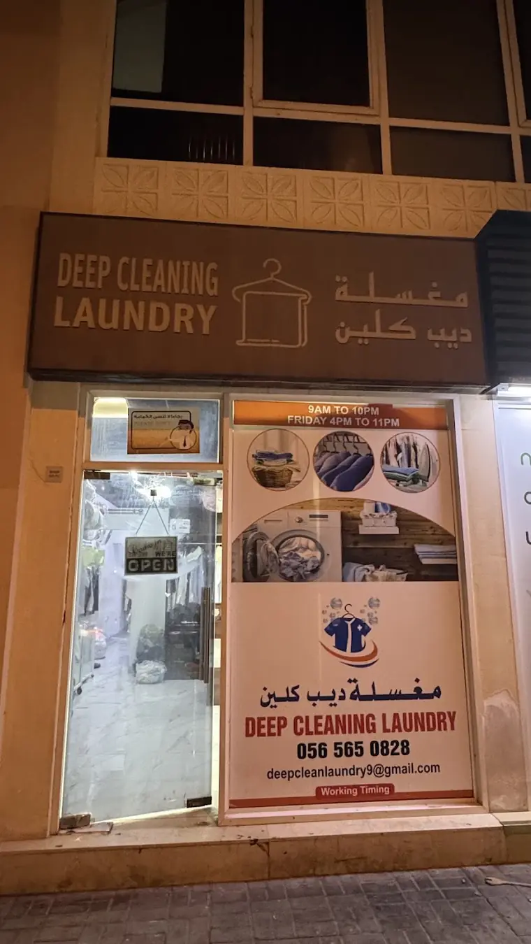 Deep Clean Laundry shopfront at night in Maple 1, JVC, with its sign in English and Arabic